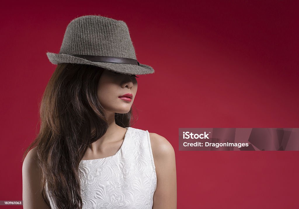 Vogue girl Copy-spaced image of a fashionable girl in hat over a red background Adult Stock Photo