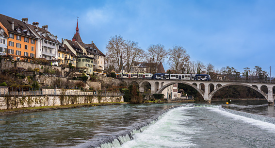 Bremgarten, Switzerland - December 7, 2023: Bremgarten is a small town and municipality in the canton of Aargau in Switzerland. The train on the bridge over river Reuss