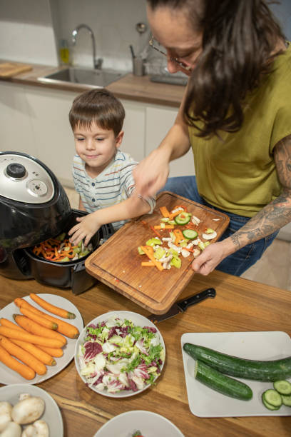 istock Cute boy and his mom making veggies for lunch 1839643929