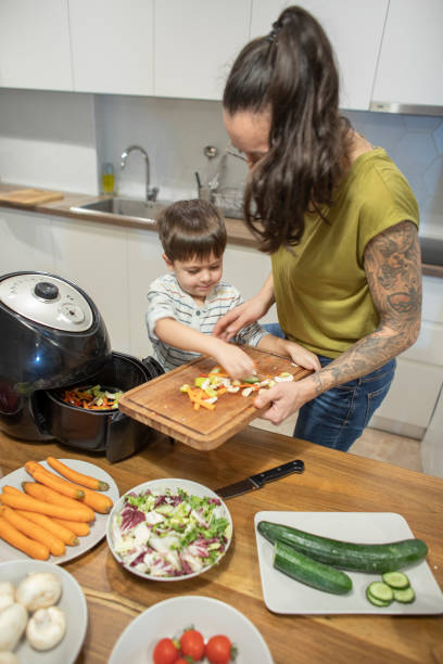 istock Boy and his mom cooking veggies 1839643931