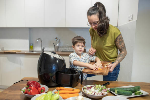 istock Boy helping his mom to prepare vegetables 1839643937