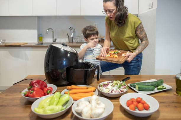 istock Woman teaching her little son cooking 1839643938