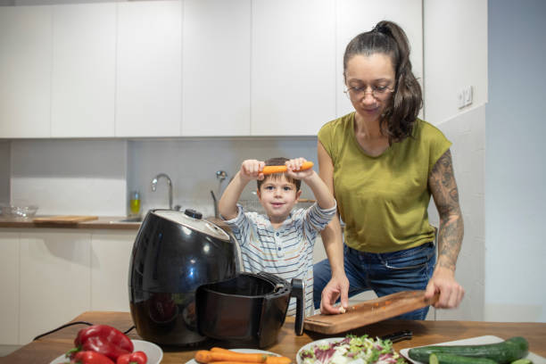 istock Happy little boy having fun cooking with his mom 1839643941