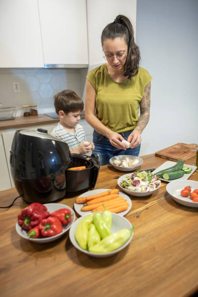 istock Woman teaching her son how to prepare veggies 1839643947