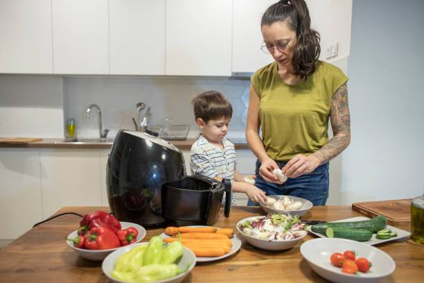 istock Mom teaching her son how to prepare veggies 1839643949