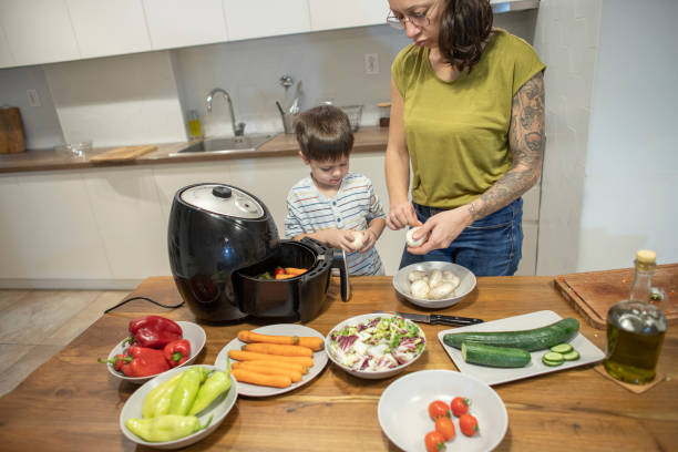istock Cute boy cleaning mushrooms while cooking with his mom 1839643950