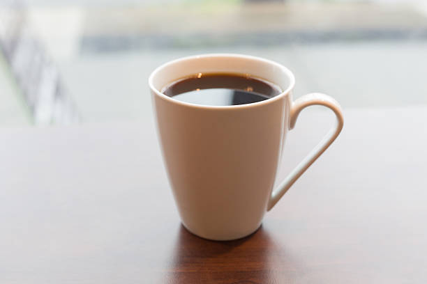 istock Warm cup of coffee by the window 183964702