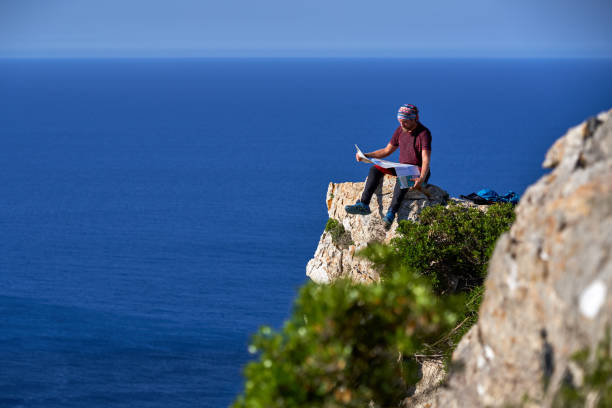 istock Male tourist reading paper map in mountains 1839656440