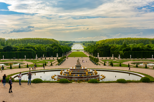 Paris, France - May 2019: Latona fountain and Versailles park landscape at sunset