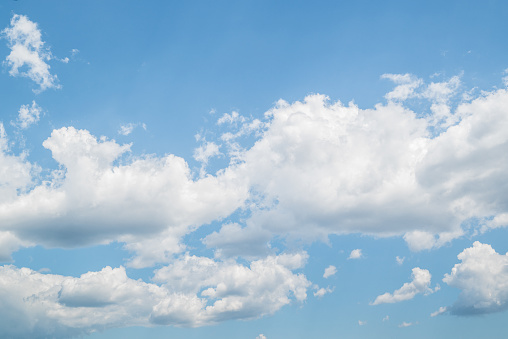 White clouds in the bright blue sky. The beauty of the nature