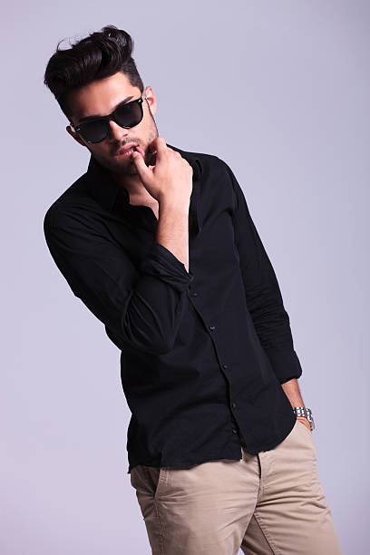 istock young fashion man touches lower lip 183966812