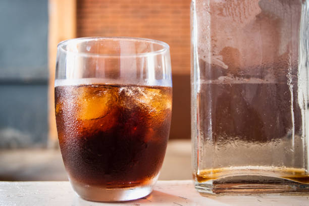 Cold-brewed coffee in a clear glass with a clear bottom.