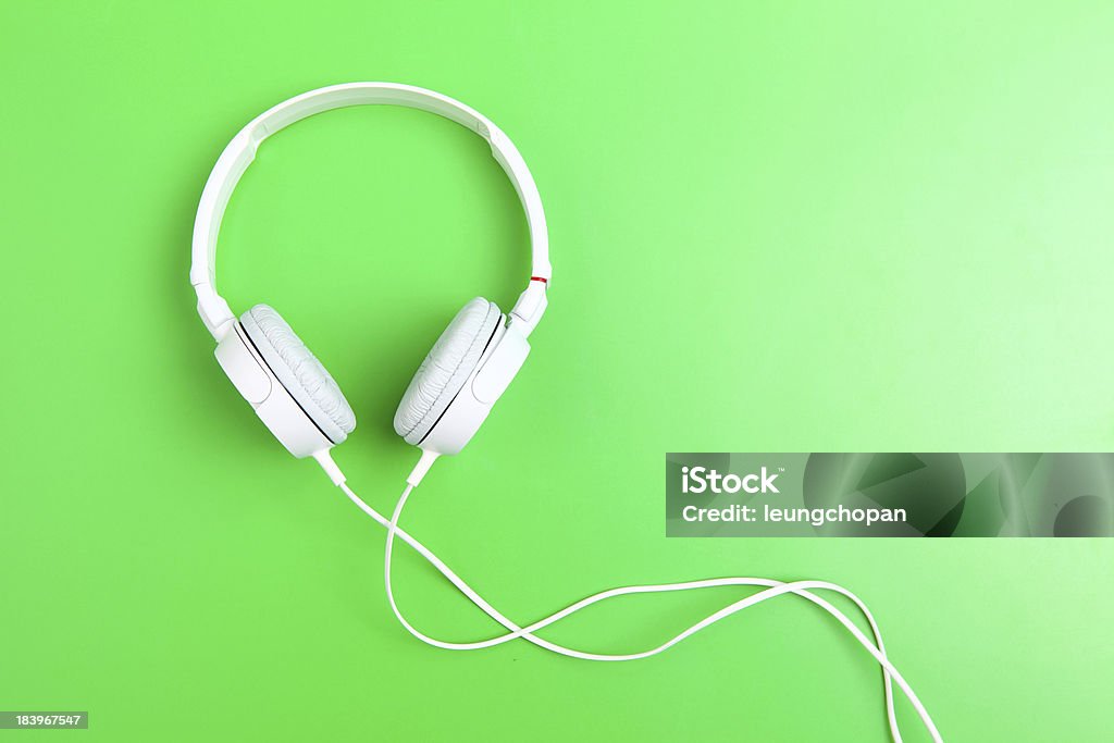 Headphone on green background Arts Culture and Entertainment Stock Photo