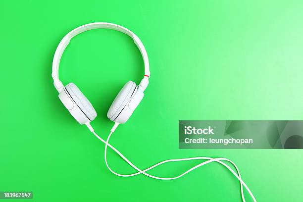 Headphone On Green Background Stock Photo - Download Image Now - Arts Culture and Entertainment, Audio Equipment, Cable