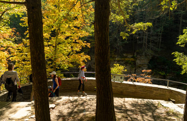 Autumn in Watkins Glen State Park, near Seneca Lake, New York State, USA.  There are people on the footpath near the gorge.