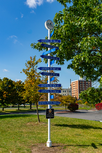 The lakeside at Geneva, New York State, USA.  A series of distance signs too other Genevas.