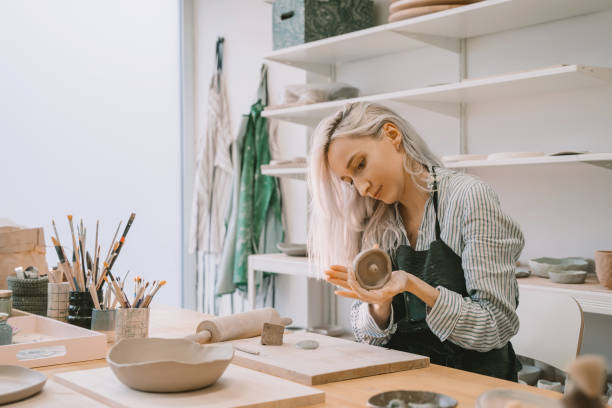 istock Female craftsperson working on ceramics tableware on pottery workshop. 1839742583
