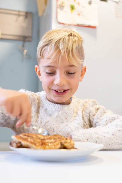 istock Boy eating homemade pancakes in the kitchen 1839757132