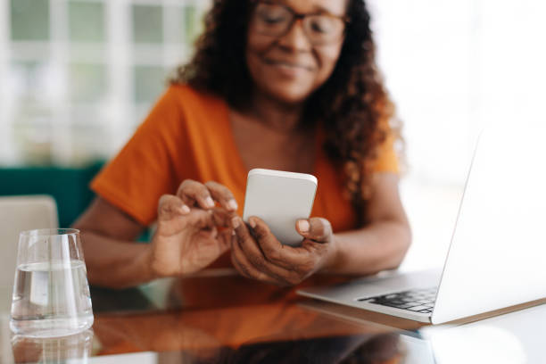 istock Senior woman using a smartphone to connect with her team in a hybrid work model 1839760323