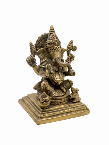 lord ganesh with four hands sitting brass statue with intricate details and decorative carvings isolated in a white background