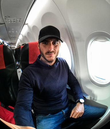 man take a selfie inside the plane