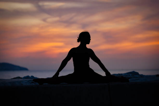 istock Female yogi is exercising at sunset. 1839800832