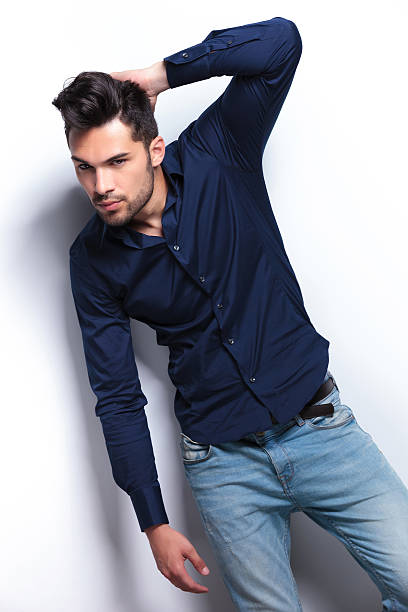 istock young man with a hand in his hair 183980466