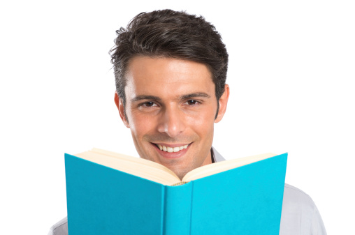 Portrait Of A Happy Young Man With A Book Isolated On White Background