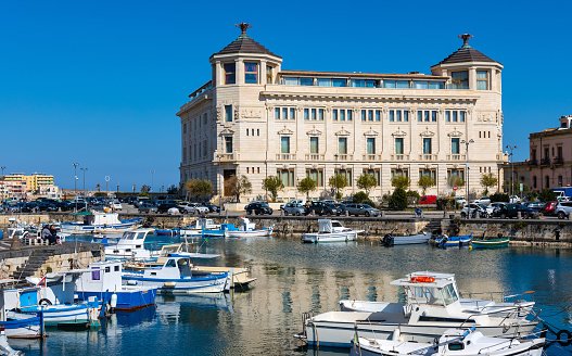 Syracuse, Sicily, Italy - February 16, 2023: Palazzo delle Poste Palace with Ortea Hotel Autograph at piazza delle Posta square and Syracuse yacht port