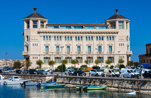 Syracuse, Sicily, Italy - February 16, 2023: Palazzo delle Poste Palace with Ortea Hotel Autograph at piazza delle Posta square and Syracuse yacht port