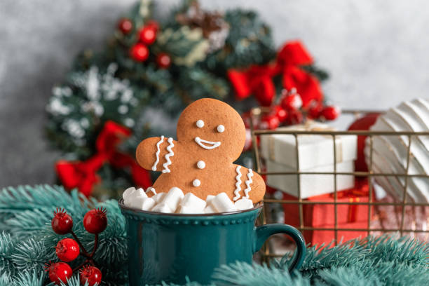 istock Gingerbread man cookies in a cup with marshmallows , gray background. Christmas symbol. Selective focus. 1839868315