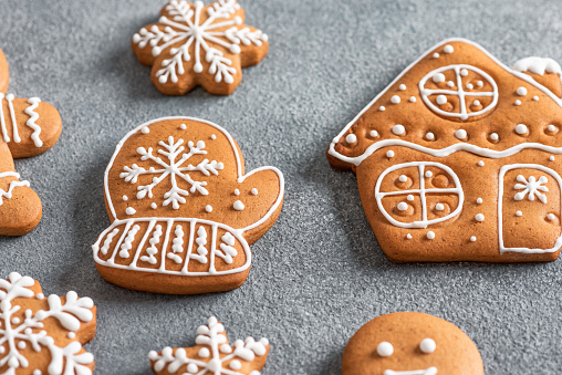 Christmas gingerbread cookies closeup on a gray background. Flat lay, above, selective focus. Gingerbread mitten.
