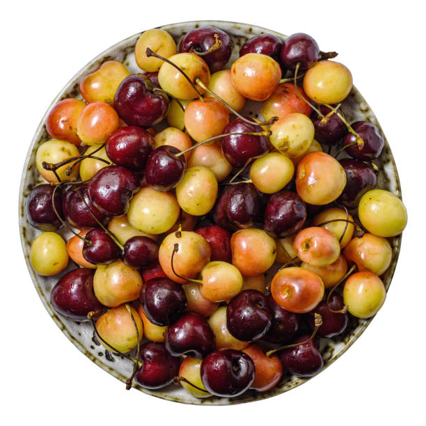 istock Fresh sweet multicolored cherry on plate isolated above 1839875749