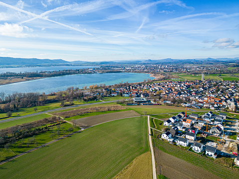 Luftaufnahme von Markelfingen mit dem Neubaugebiet im Vordergrund und Radolfzell sowie Singen mit der Burg Hohentwiel im Hintergrund