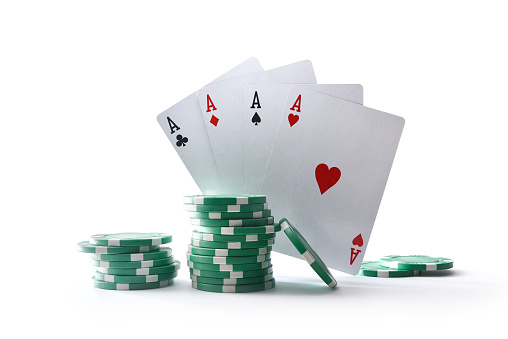 Background with cards of aces and chips for betting isolated on white table and background. Front view.