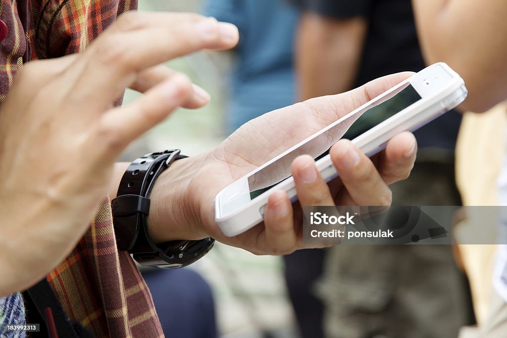 Teenage girl text messaging on her phone Holding Hands Stock Photo