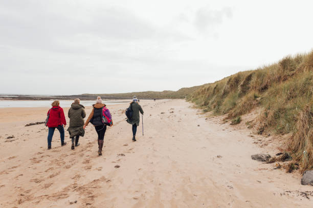 istock Women's Walk Through Dunes by the Sea 1839925575