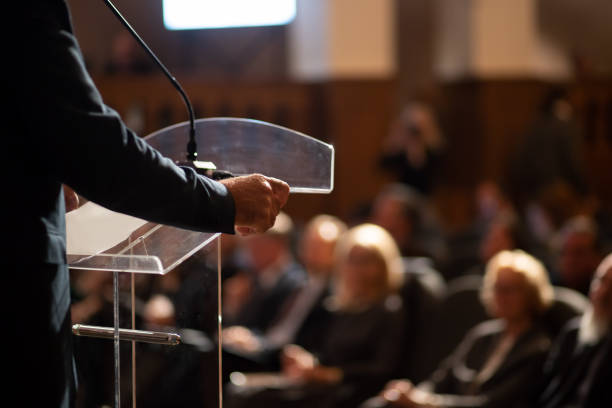 unrecognizable man having a speech in front of audience stock photo