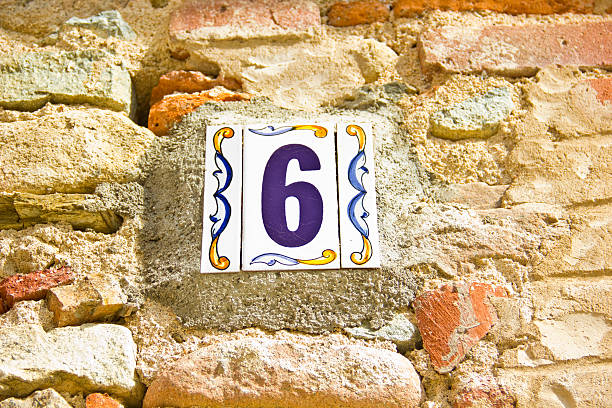 istock Number six in a ceramic tile on street 183995113