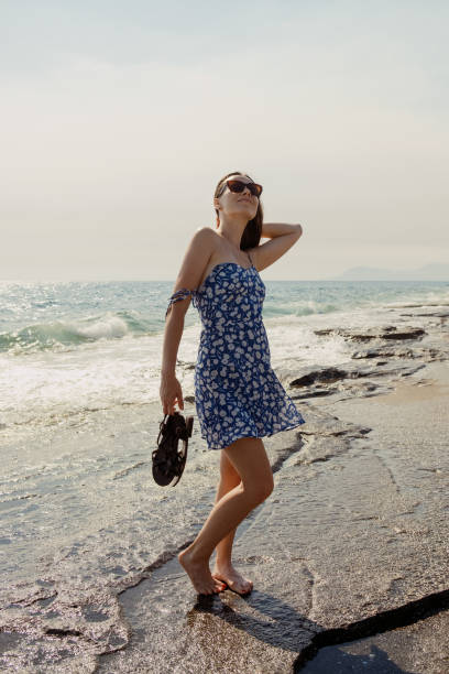 istock Seashore Solace: Woman in Blue Dress 1839952405