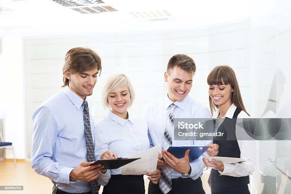 business people working office business people group working looking to paper documents at office, discussion on meeting, happy group businesspeople smile holding clipboards, team cooperation, communicate at conference hall Business Person Stock Photo