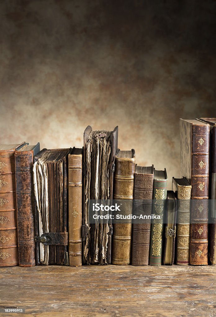 Ancient books in a row Row of ancient books leaving plenty of copy space Ancient Stock Photo