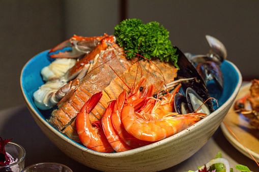 Seafood platter with prawns, mussels, and fish. Gourmet dining experience.