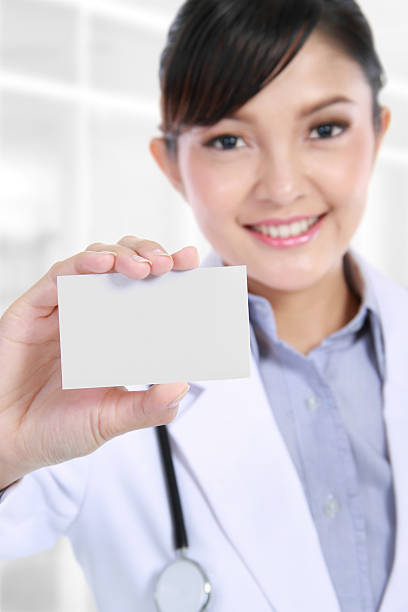 istock doctor holding blank business card 183997020