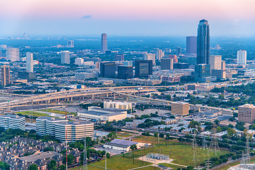 Aerial view of the Galleria section of Houston, Texas located just a few miles from downtown featuring the Williams Tower and the Galleria Mall along with other office and residential buldings shot from a helicopter at sunset from an altitude of about 500 feet.