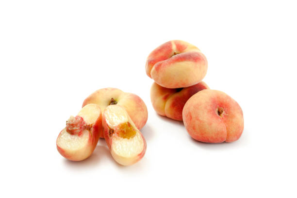 istock Half and several whole saturn peaches or flat peaches isolated on white background with clipping path. 1840008351