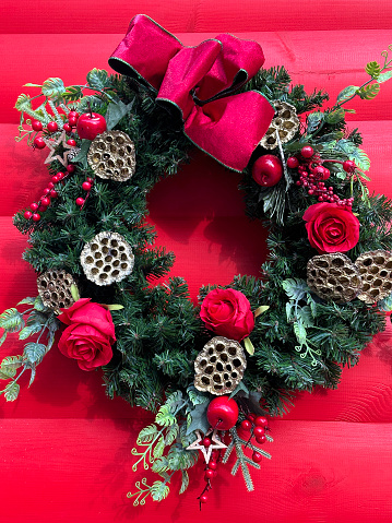 Christmas wreath on a red wall outdoor