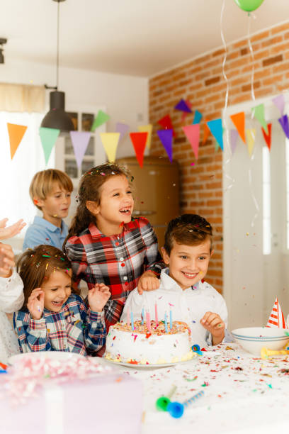 istock Children having fun with confetti on a Birthday celebration 1840015254