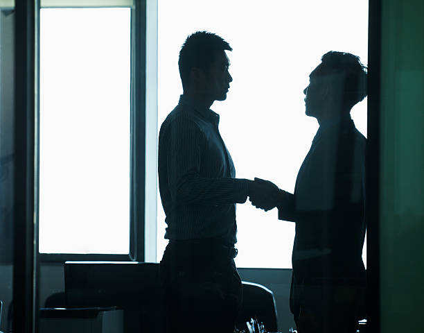 istock Businessmen shaking hands in office 184003728