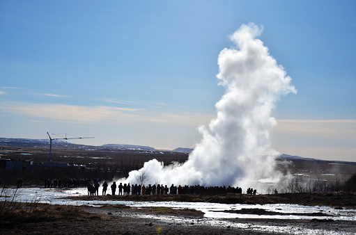 Icelandic geyser with tourists. Icelandic landmarks.